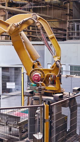 Industrial background with robotic equipment. Factory robot machine. Manufacturing production. Futuristic technologies. Vertical video