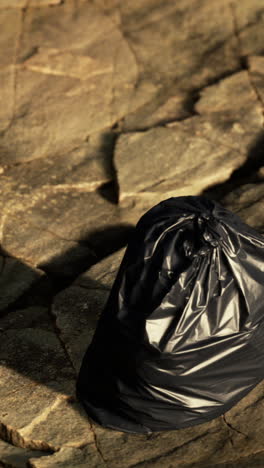 black trash bag on stone ground