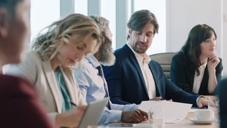 corporate business people meeting in boardroom brainstorming colleagues discussing strategy sharing problem solving ideas working on deadline collaborating in busy office 4k