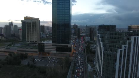 beautiful sunset in ulan bator traffic and buildings aerial drone shot big tower