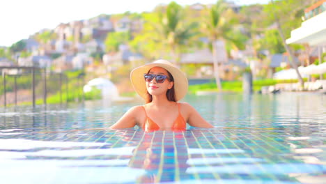A-young-woman-in-a-resort-swimming-pool