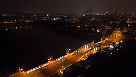 night aerial view of a bridge over a river in a european city
