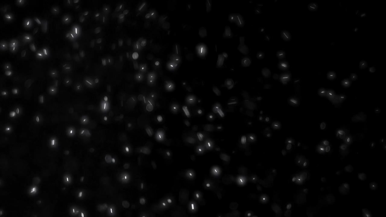 Floating White Dust Particles Against Black Background