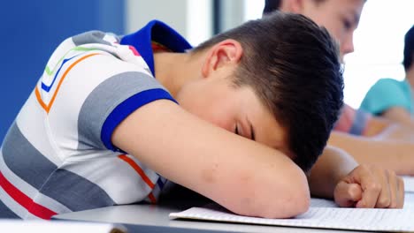 tired student sleeping in classroom