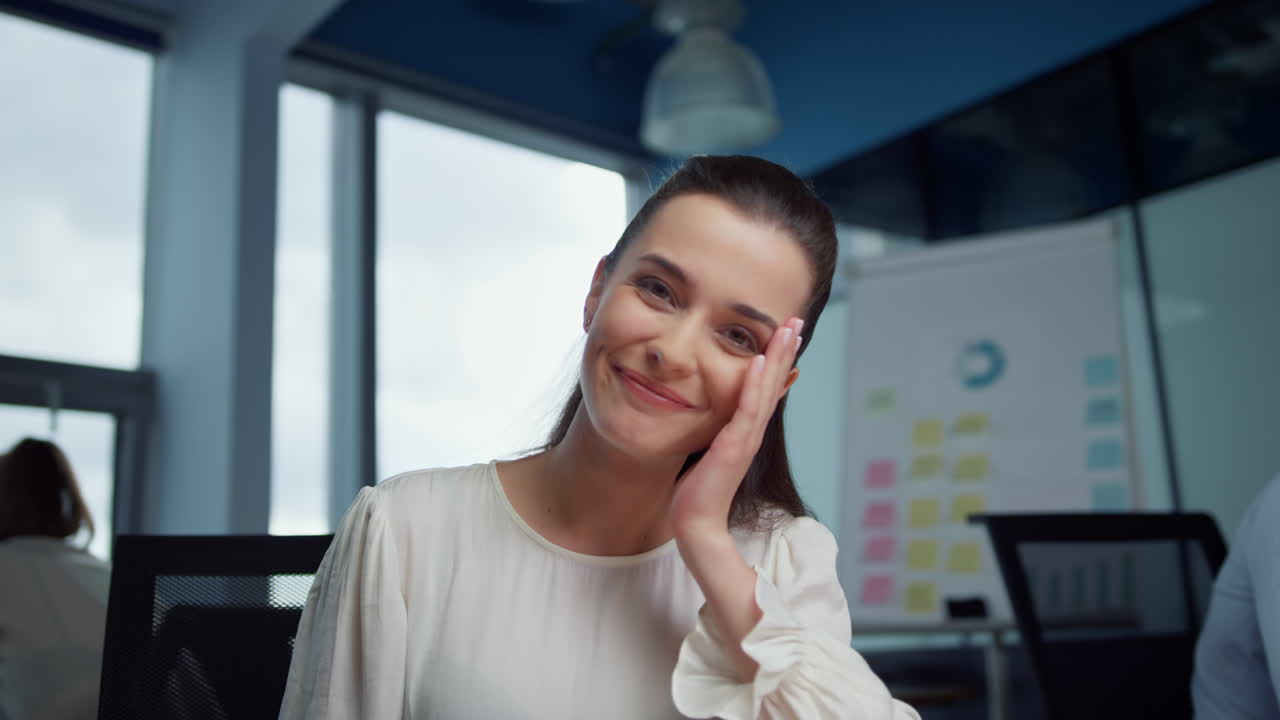 Smiling business woman calling video online at camera