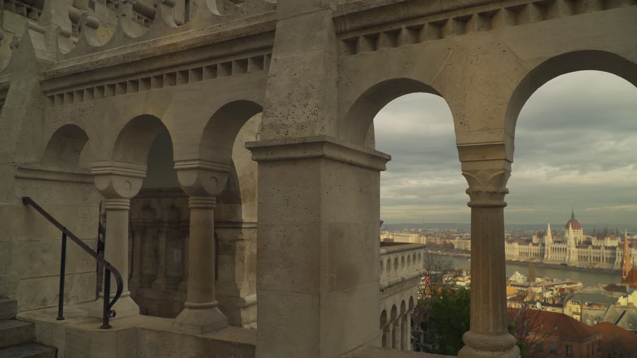 Staircase And Arch Windows Of The Fisherman's Bastion Overlooking View Of Budapest - panning medium shot