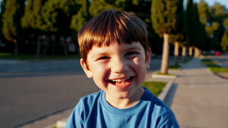 happy young boy laughing outdoors