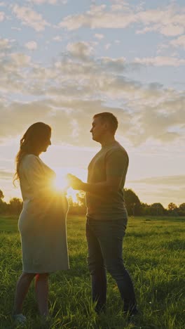 pregnant couple at sunset