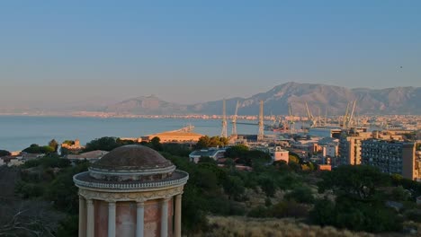 the beautiful palermo pier by the mountains of italy - aerial