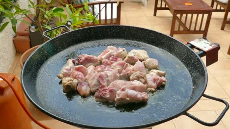sartén típica para la paella valenciana para cocinar pollo en aceite de oliva