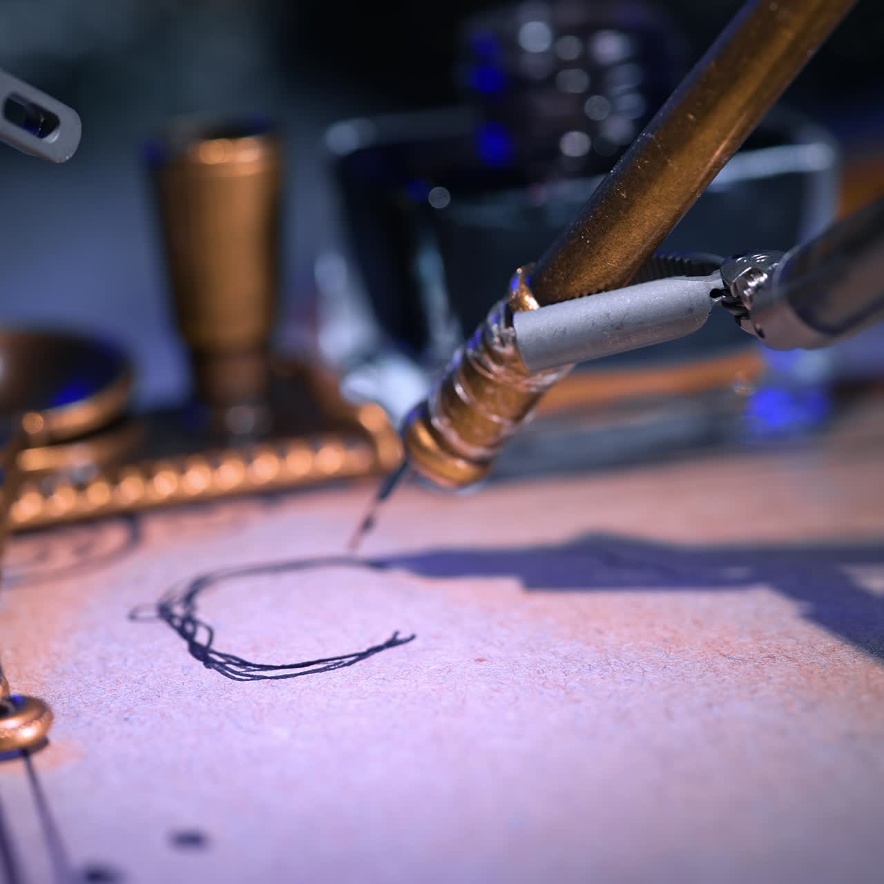 Old writing pen drawing lines on the paper. Robotic arm holding a pen managing writing. Close up. Blurred backdrop