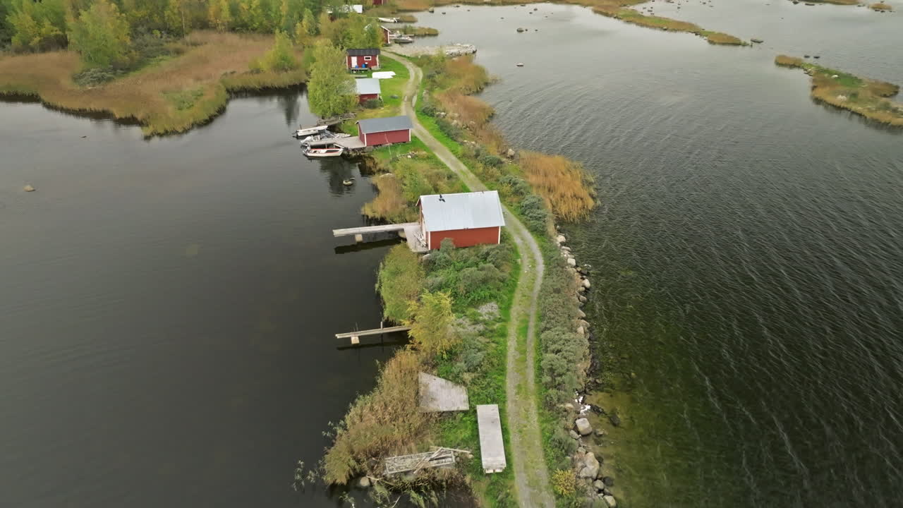 An Island With Red Little Fisherman's Houses On Lake In Finland, Europe