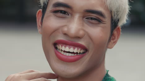 smiling person with makeup and short hair