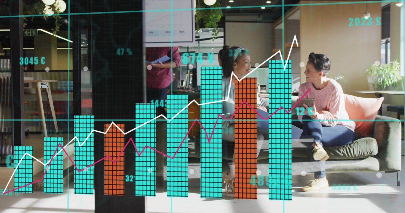 Two colleagues chatting on tablet in lounge, generating financial overlays and rising bar chart
