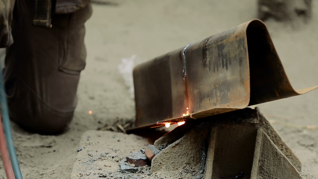 Workshop factory cutting metal. Man working with air plasma cutting of steel metal