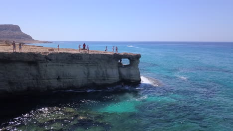 Aerial-shot-of-sea-caves-at-a-beautiful-rocky-sea-coast