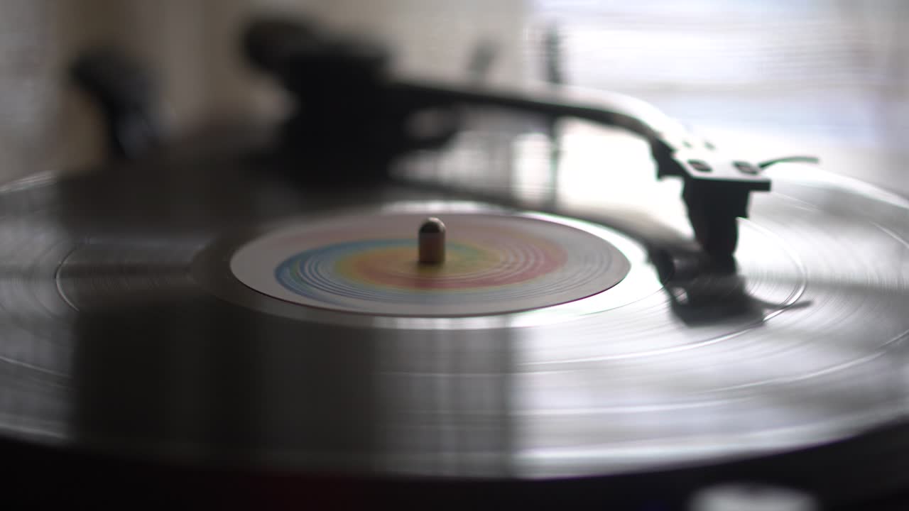Close Up of Spinning Vinyl Record on Vintage Turntable in Room Ambience