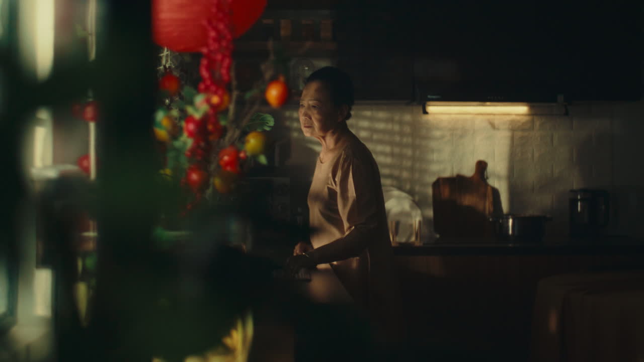 Elderly Woman in Kitchen During Celebration