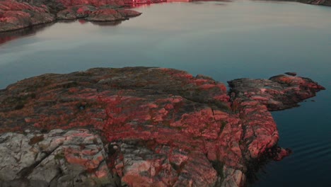 drone flies over swedish archipelago at sunset in skarhamn