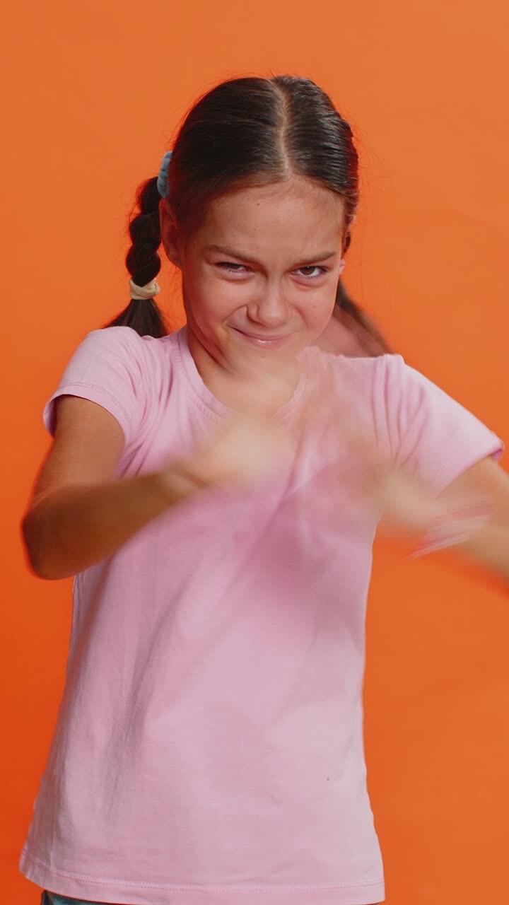 Frustrated young school girl kid covering ears ignoring unpleasant noise loud voices avoiding advice