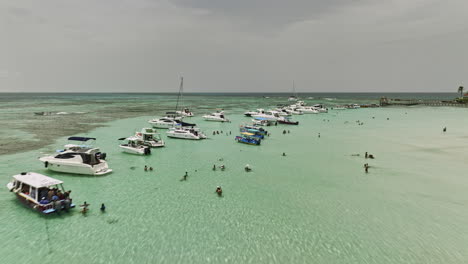 isla mujeres mexico aerial v17 low flyover island sandbars capturing catamarans and boats on the crystal clear sea water with people swimming and snorkeling around - shot with mavic 3 cine - july 2022