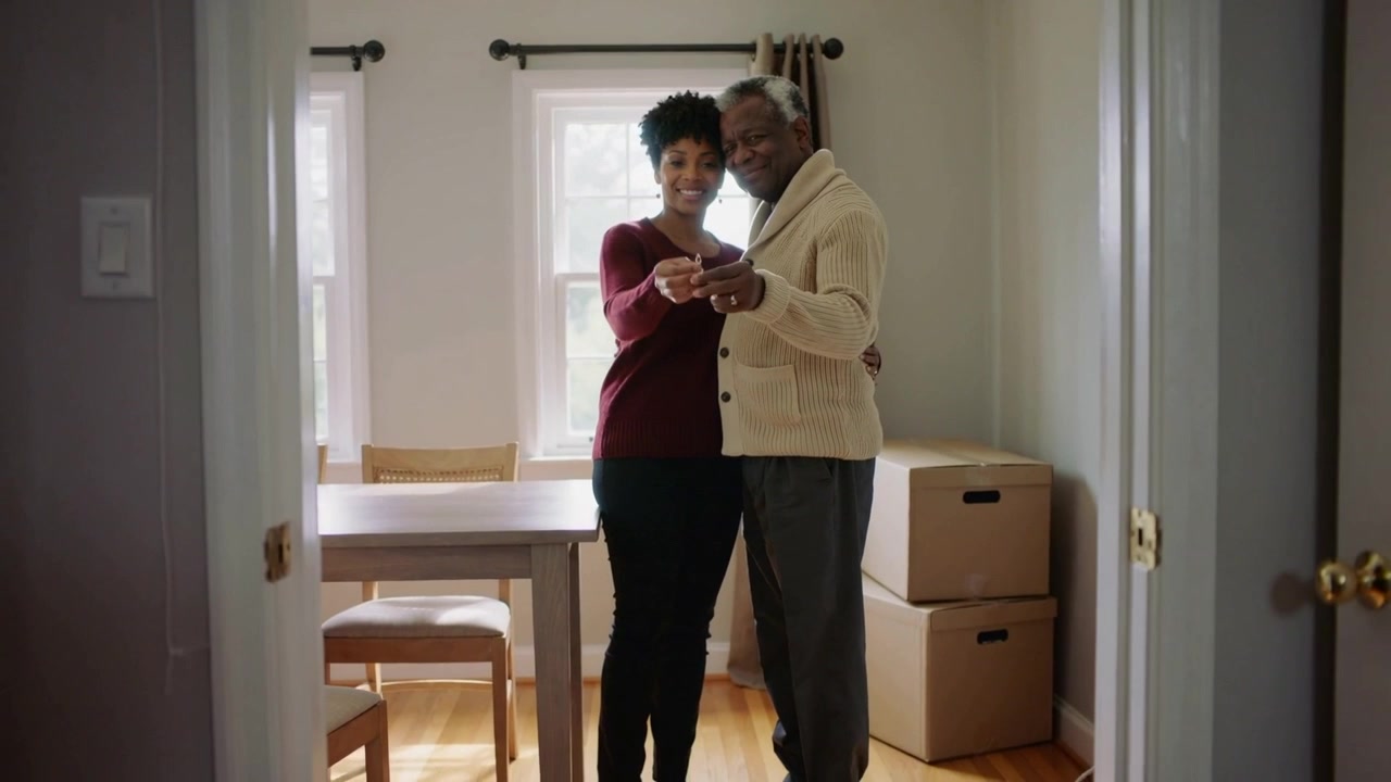 Receiving keys, couple showing them at home with boxes, marking move, woman in burgundy sweater