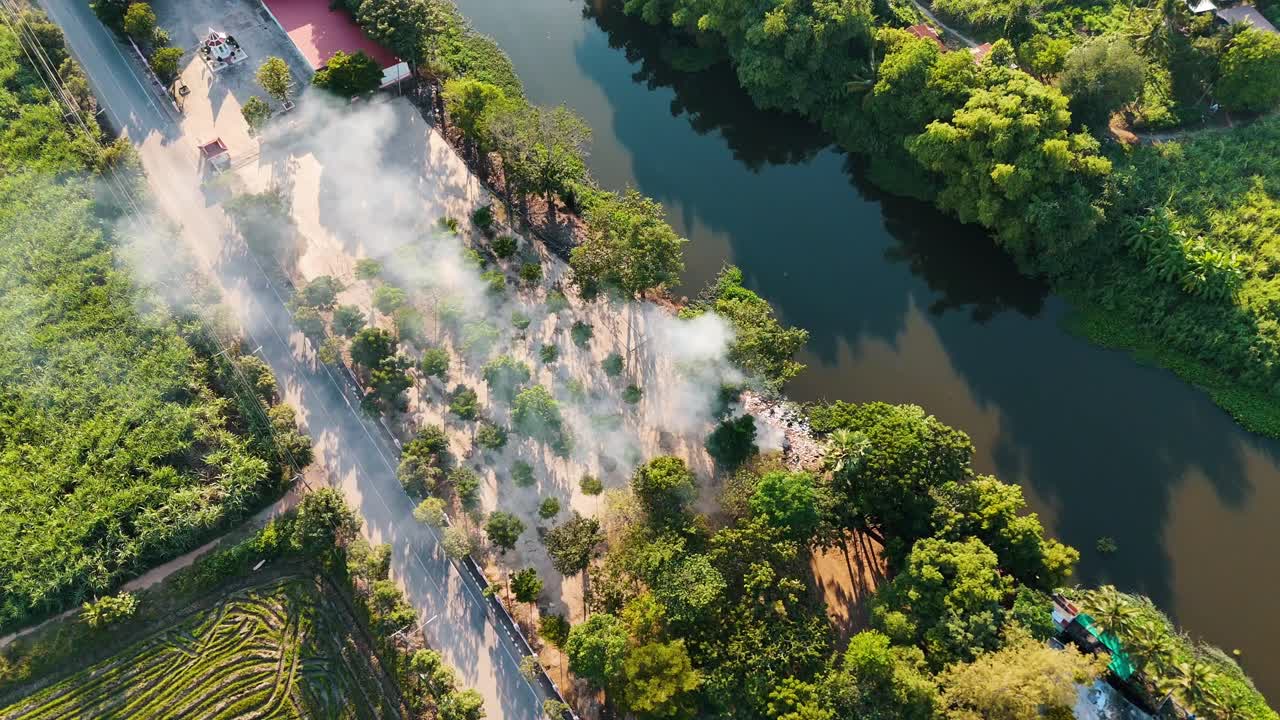 Smoke rising up from a small village in the west of Thailand surrounding in forests
