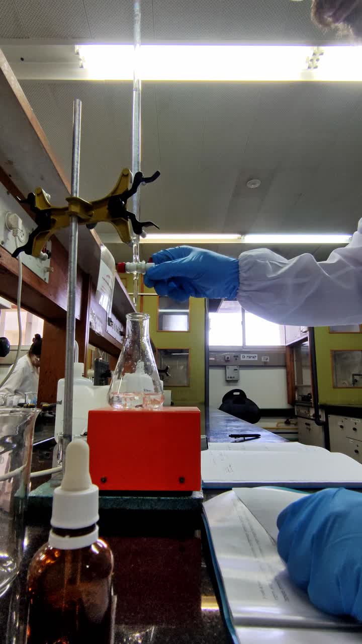 Chemist Operating a Burette in the Laboratory