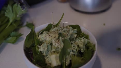 Finishing a vegan tuna salad bowl with freshly squeezed lemon