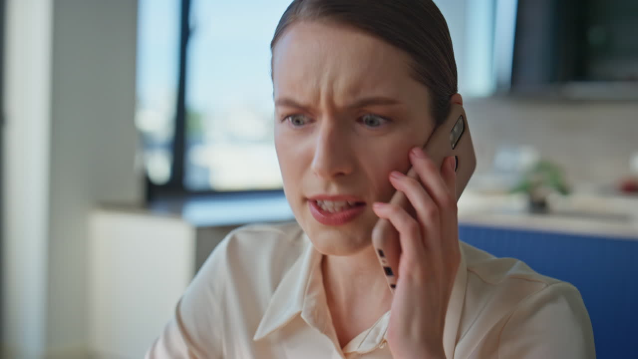 Irritated lady arguing smartphone discussing work trouble in office closeup