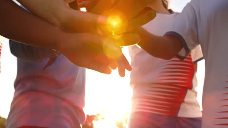 close-up of female soccer team clasping hands 4k