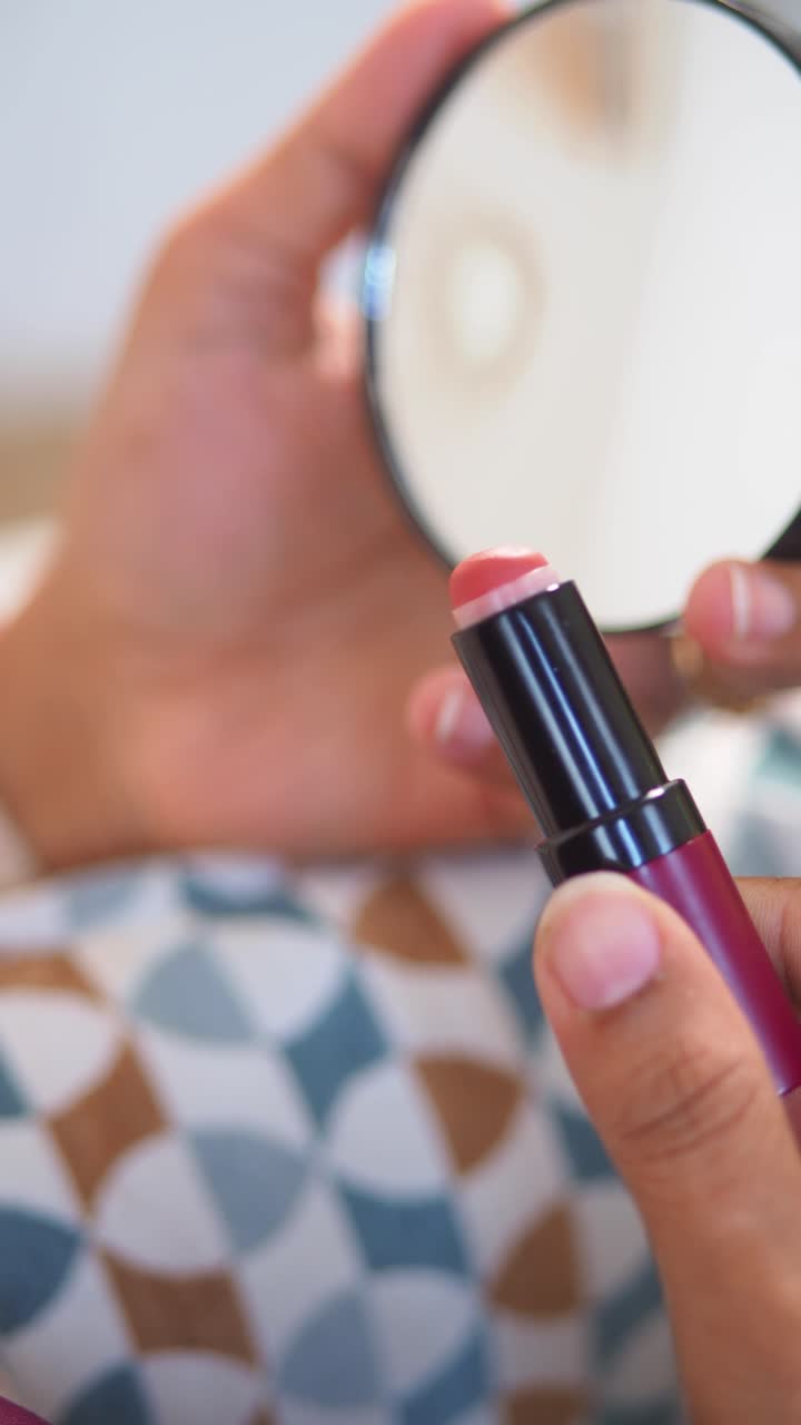 Close-up of Hands Holding Lipstick and Compact Mirror