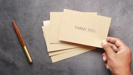 hand holding thank you cards