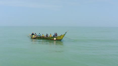 _aerial shot of a boat or canoe fishing in a sea during the day_25