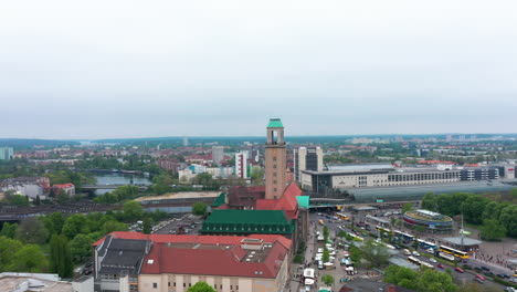 Aerial-view-of-heavy-traffic-in-city-centre.-Busy-multilane-road-near-railway-bridge-at-train-station.-Historic-town-government-building-with-tower.-Berlin,-Germany