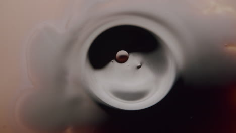 Macro-shot-of-a-smooth-black-liquid-forming-a-circle