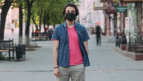 young man wearing a mask in the city