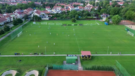 rotating the camera around the soccer field during the game just as the soccer players score a goal