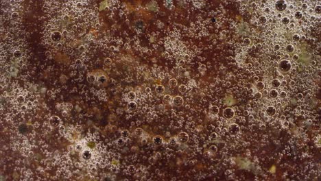 macro abstract spirling gross bubbling brown liquid bubbles texture background