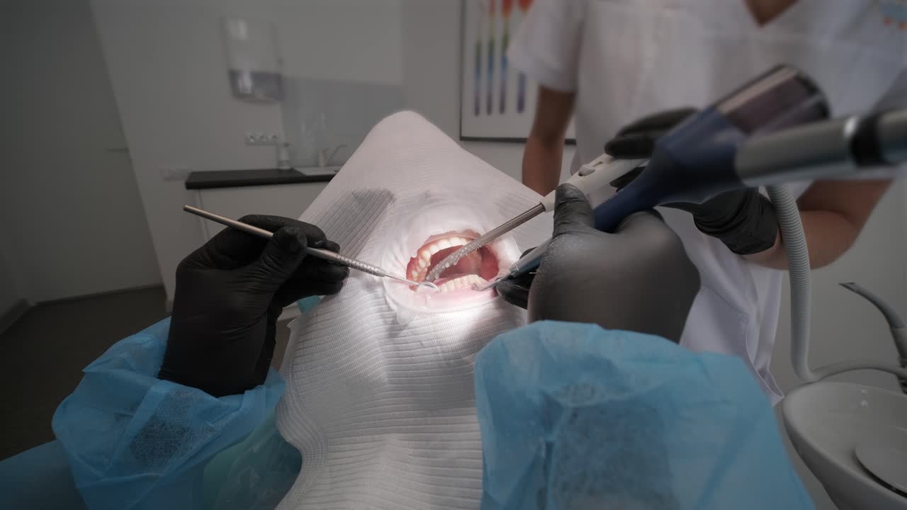 стоматолог осматривает зубы пациента у стоматолога.