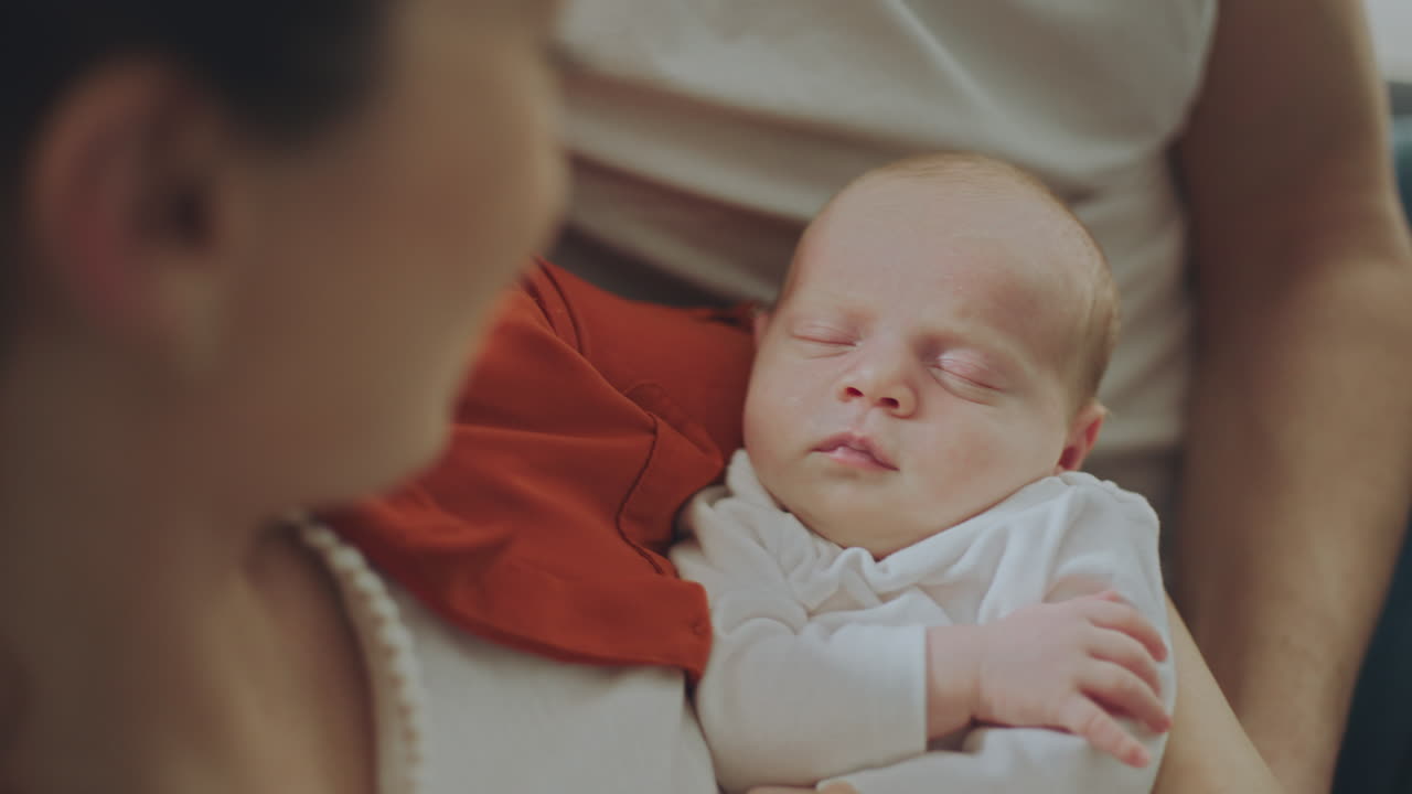 Family Watching Baby Sleep
