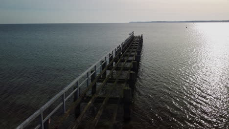 Seitwärtsflug-über-Eine-Vernachlässigte-Brücke-Im-Meer