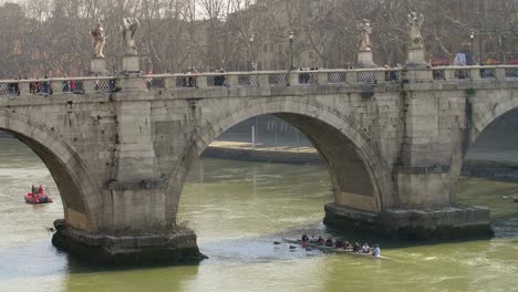 rowers under sant angelo bridge in rome