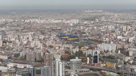 aerial panorama of sprawling buenos aires city with the iconic la bombonera soccer stadium and dense urban landscape, argentina.