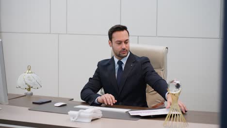 serious lawyer man working with documents and typing on a computer keyboard in an office for financial or wealth management. banking, bookkeeping, and completing tasks on desktop pc for finance review
