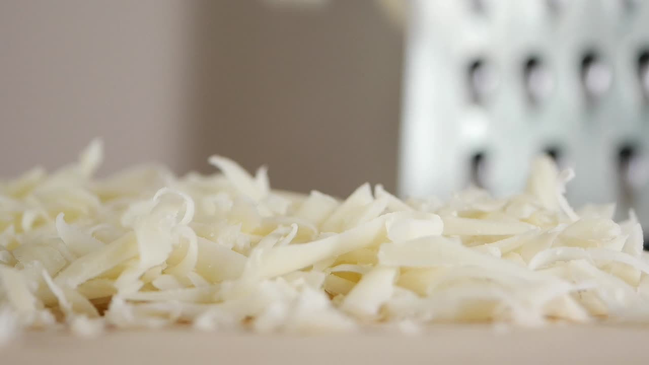 Shredded Cheese on a Cutting Board