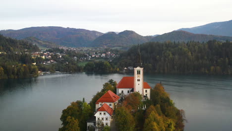 revealing cinematic aerial shot of the pilgrimage church of the assumption of mary, slovenia