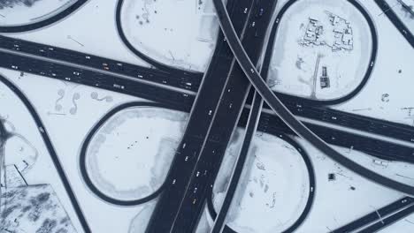 aerial view of a freeway intersection snow-covered in winter.