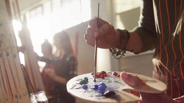 Mid section of artist holding palette 4k