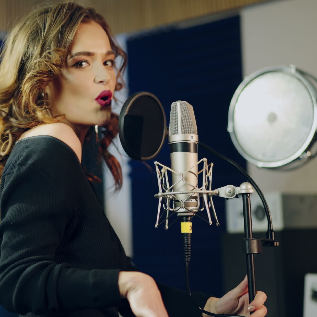 Woman singing in a recording studio. Female vocals. Professional recording studio. Square video